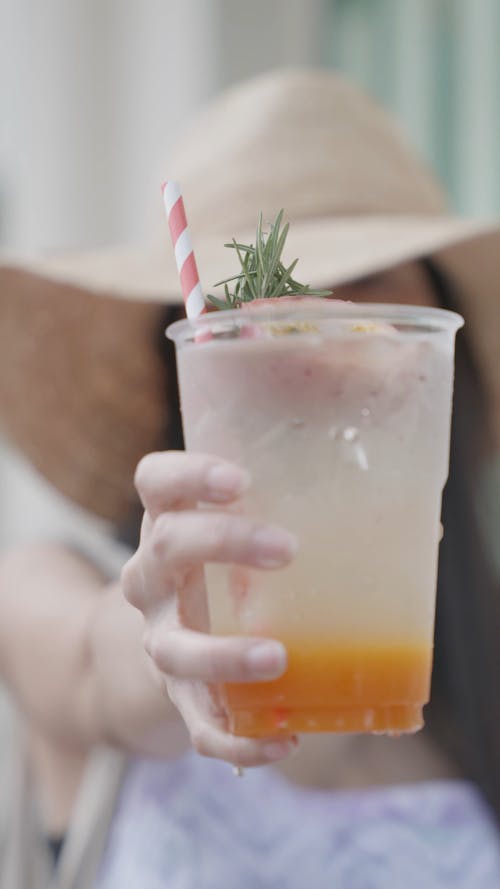 A Person Holding a Cold Drink