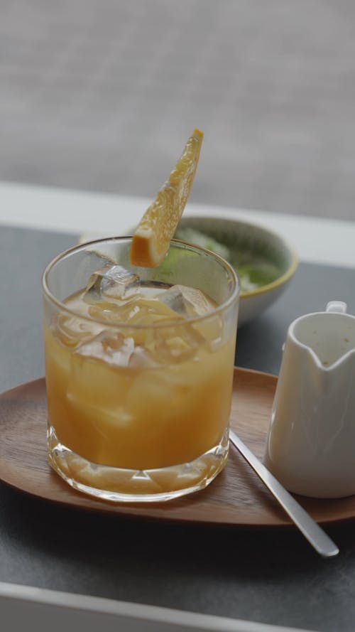 A Refreshing Orange Juice On Wooden Plate