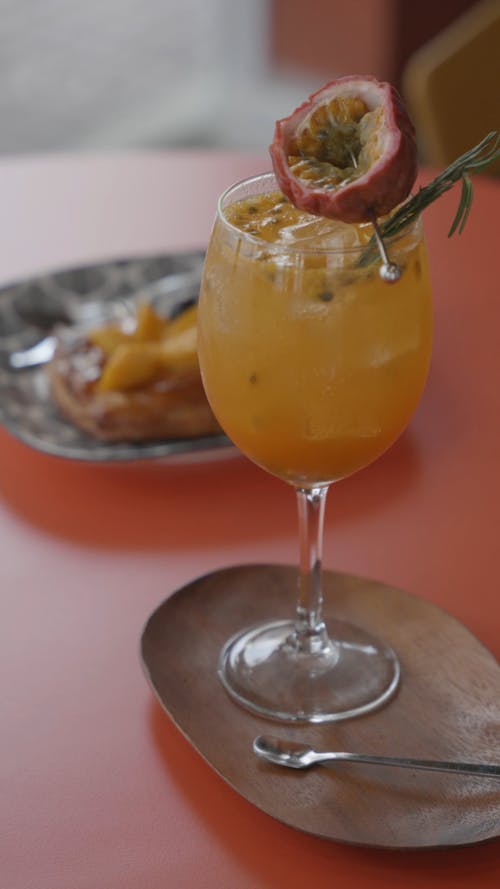 A Glass of Pomegranate Fruit on a Wooden Saucer