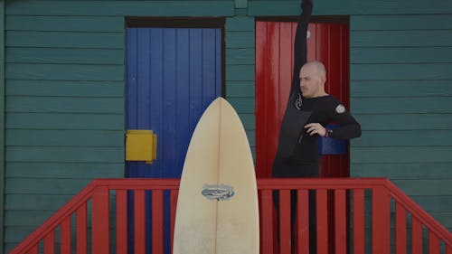 A Surfer Putting on his Wetsuit