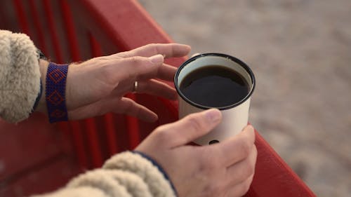 Close Up of Hands Holding a Cup of Coffee 