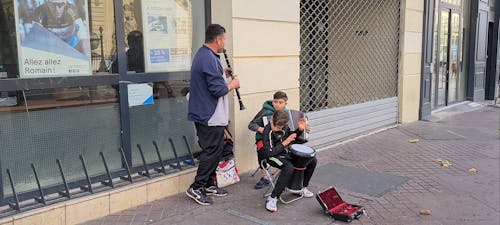 Man and his Kids Playing Music On the Streets