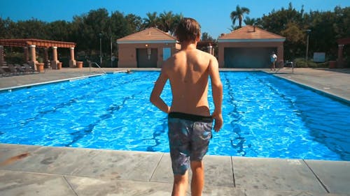 A Young Man Diving Into The Swimming Pool