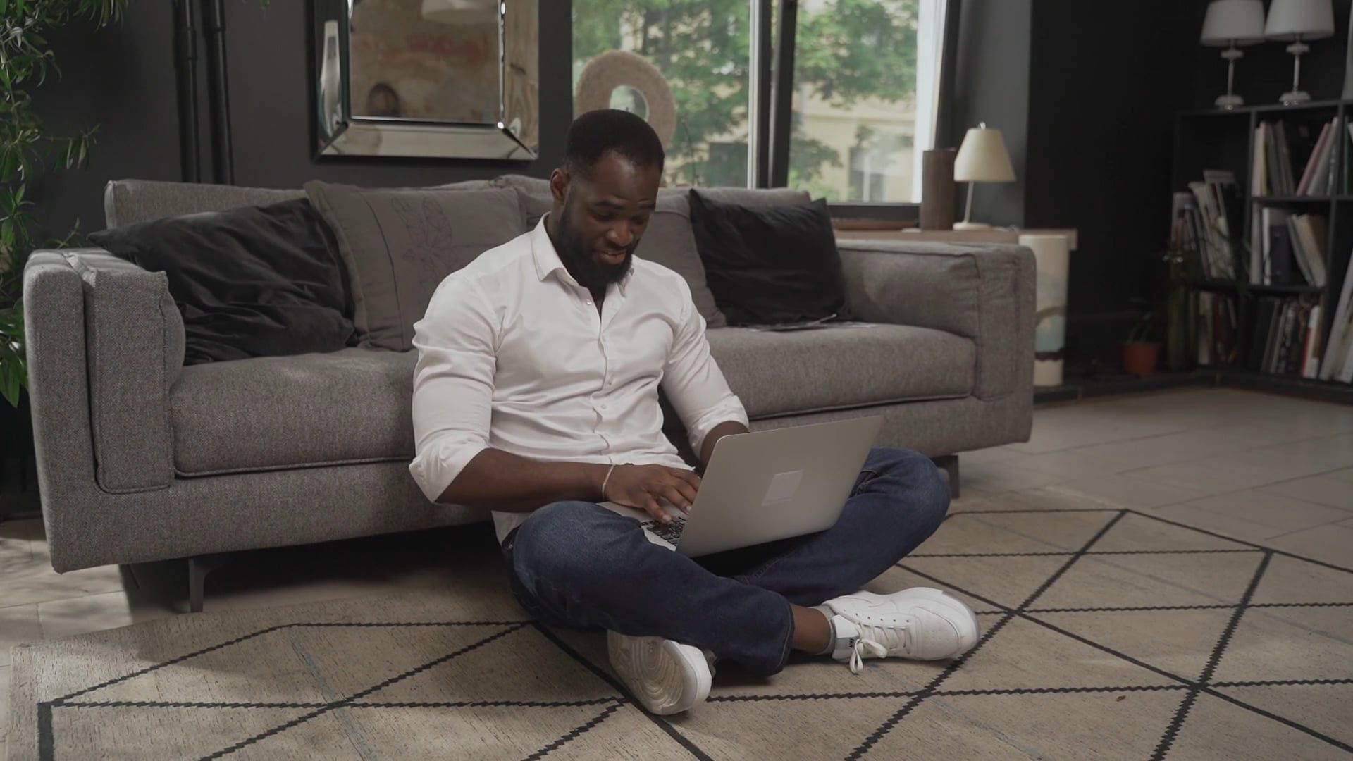 A Man Typing on a Laptop while Sitting on the Floor Free Stock Video ...