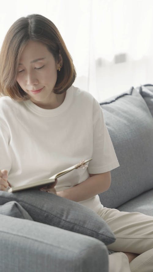 A Woman Writing in Notebook