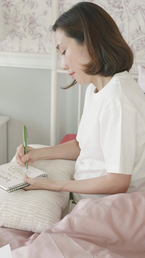 A Woman Writing in Notebook