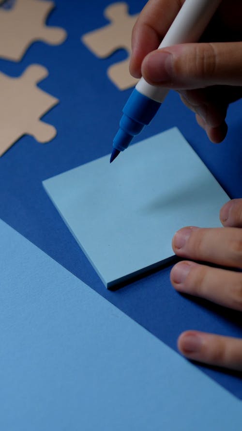 A Person Drawing on Sticky Note