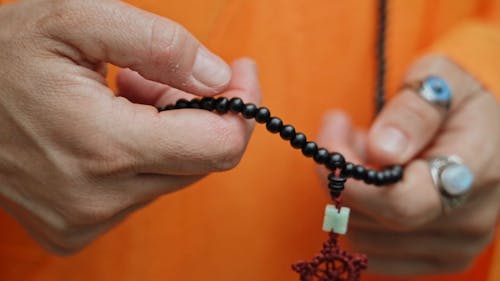 Close up of a Person Holding Prayer Beads