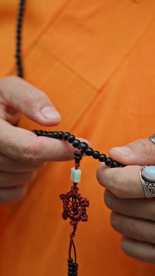 A Person Praying with Prayer Beads