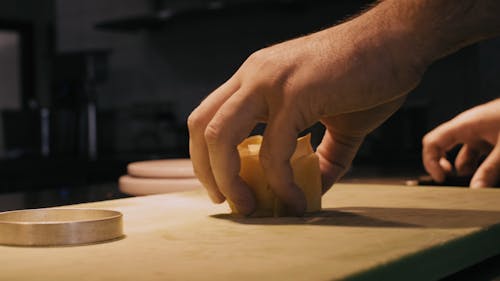 A Person Slicing Using a Kitchen Knife