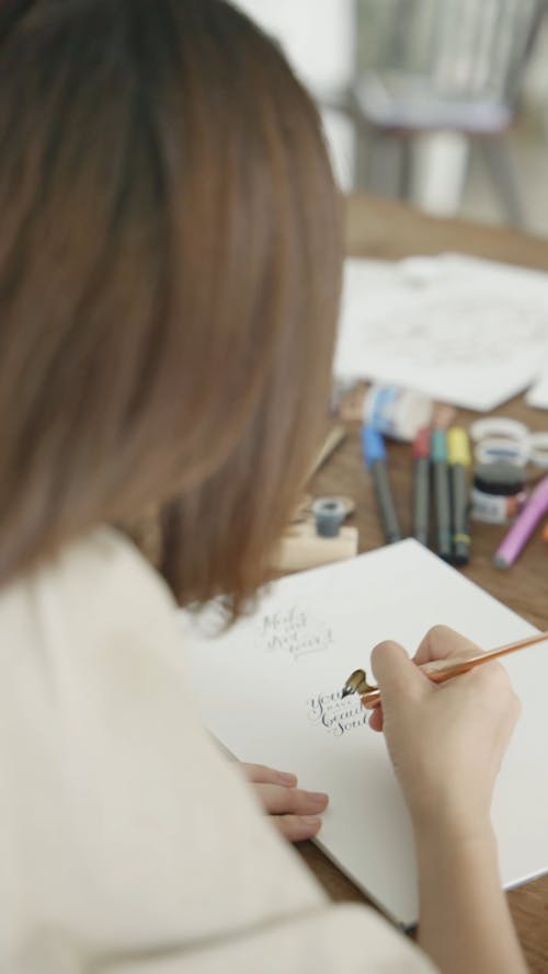 A Person Writing in Calligraphy