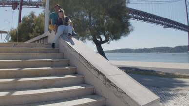 a couple sliding over a concrete ledge