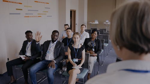 A Man Raising His Hands while Talking to the Speaker