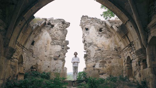 Man Praying with Rosary in Abandoned Temple 