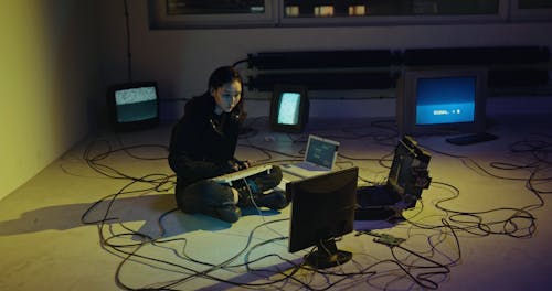 Woman Typing while Sitting on the Floor