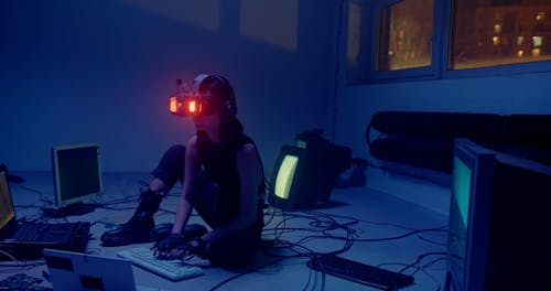 Woman Typing on a Keyboard while Wearing a VR Headset