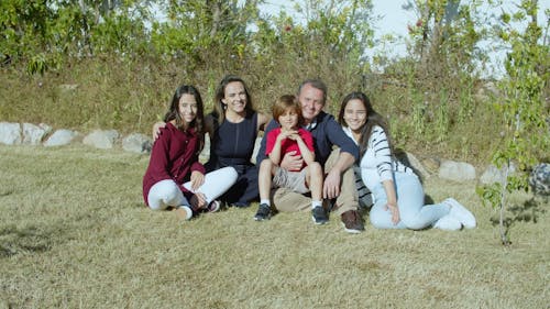 A Family Sitting on the Grass