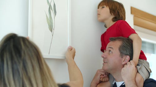 Father and Son Standing Near the Wall