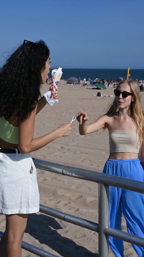 Woman Eating Ice Cream at the Beach