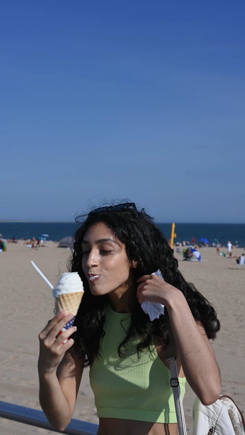 Woman Eating Ice Cream at the Beach
