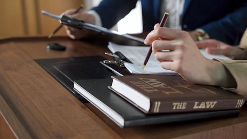 A Person Holding a Pen and Paper