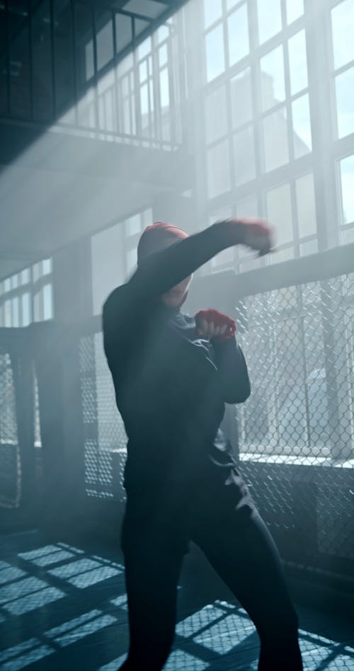 A Woman in Activewear Shadowboxing in a Gym