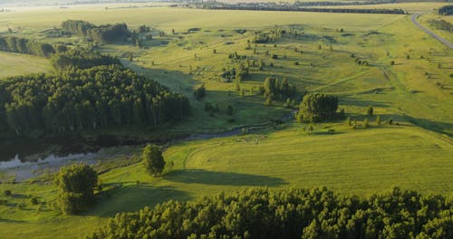 Drone View Of River Between Grasslands