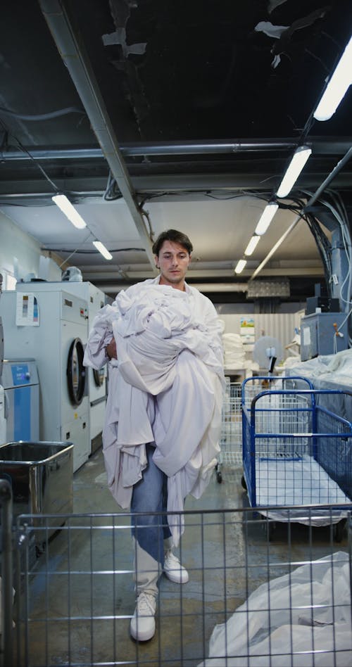 Man Putting Laundry in a Cart