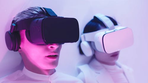 Man and a Woman Talking while Wearing VR Headsets
