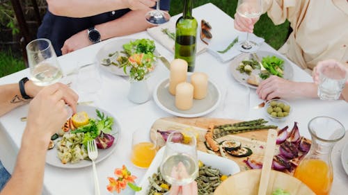 A Group of People Around a Table Toasting