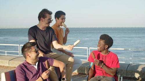 A Group of Friends Having Ice Cream in the Harbor