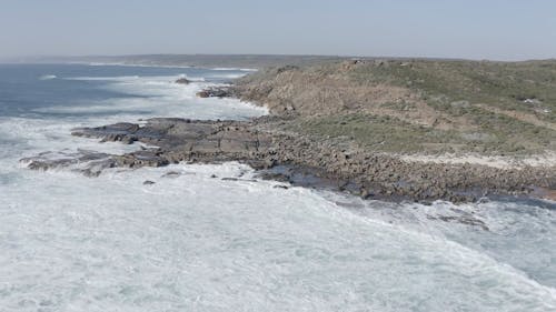 Aerial Footage of a Waves Crashing on Rocks