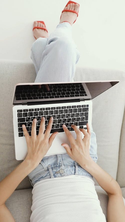 Woman Typing On a Laptop