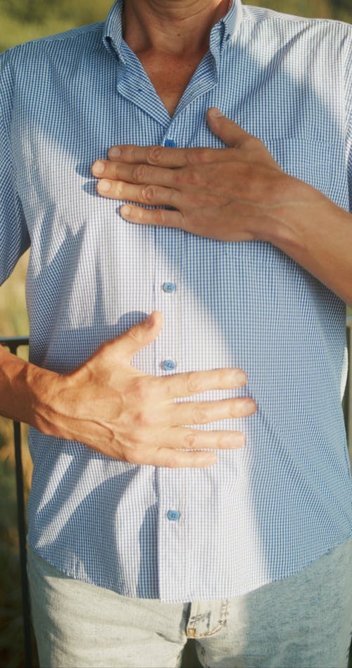 A Man Doing Deep Breathing Exercise