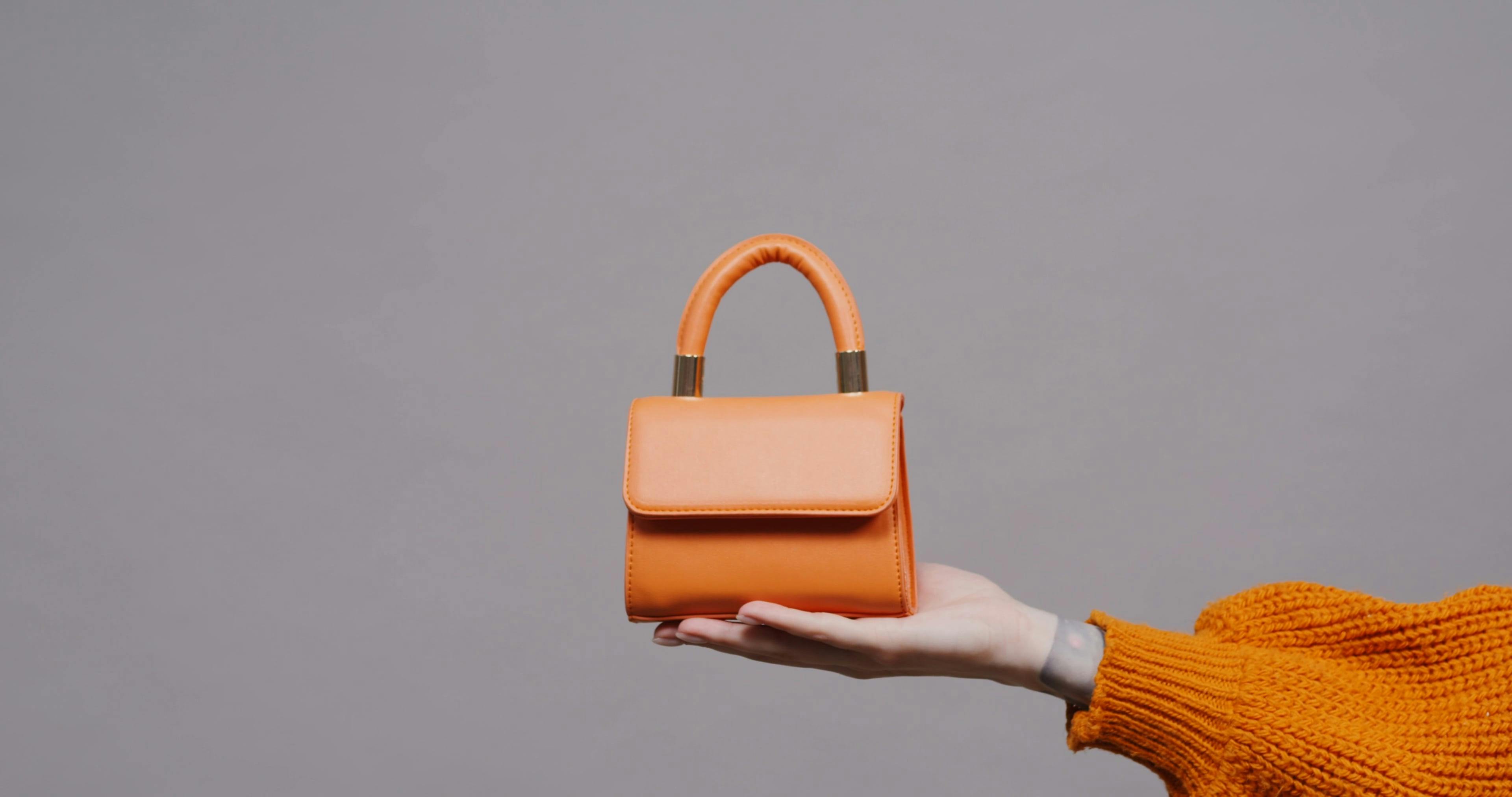 A Person Holding an Orange Handbag · Free Stock Video