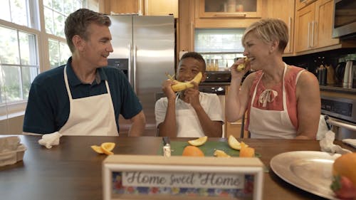 A Couple Bonding with their Child in a Kitchen