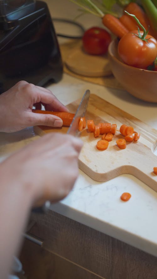 Close Up Video of a Person Slicing a Carrot