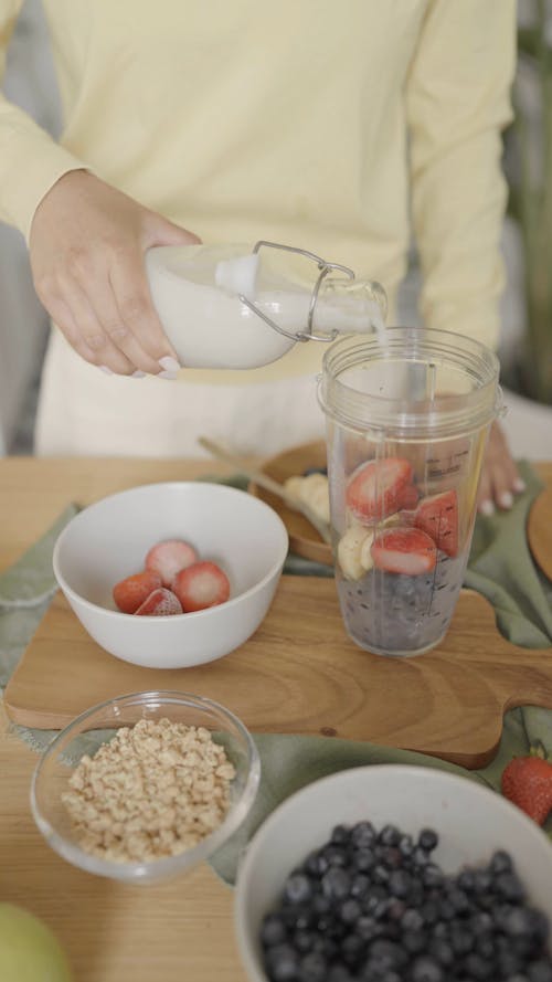 Pouring Milk in a Plastic Cup