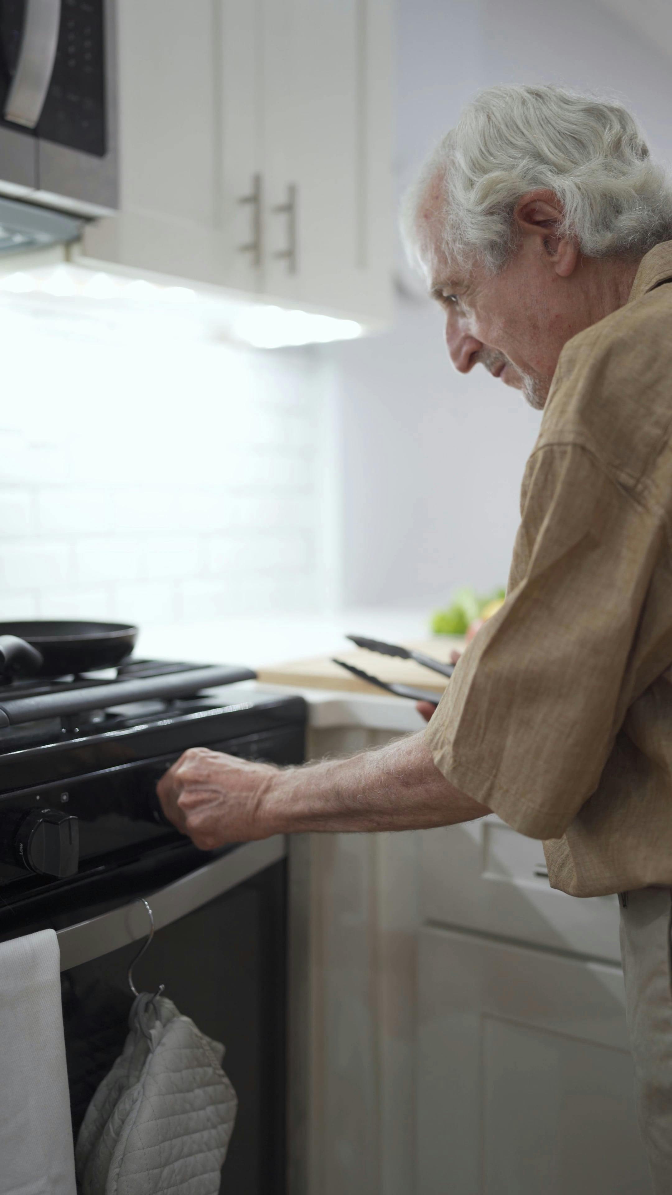 Elderly Man Turning on the Gas Stove Free Stock Video Footage, Royalty