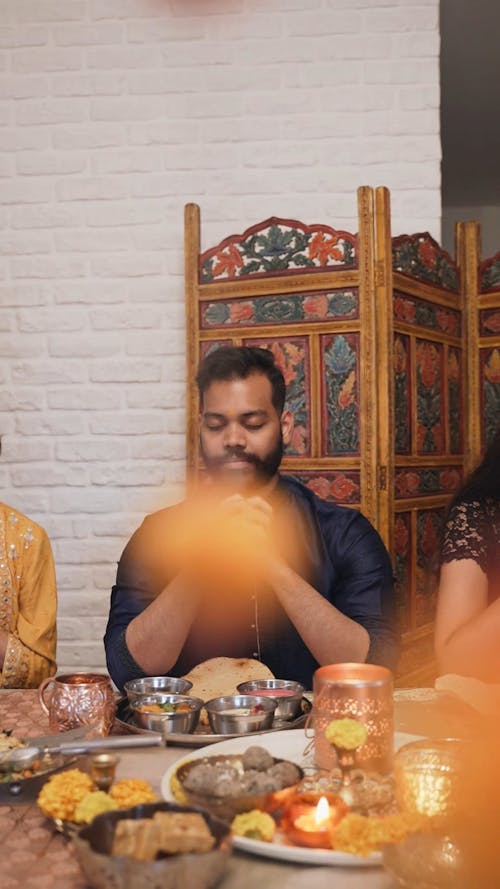 A Family Praying Together Before Meal
