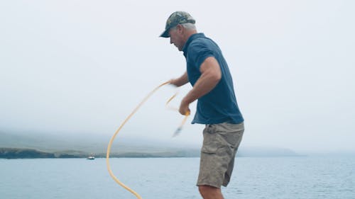 A Man Standing while Throwing His Rope 