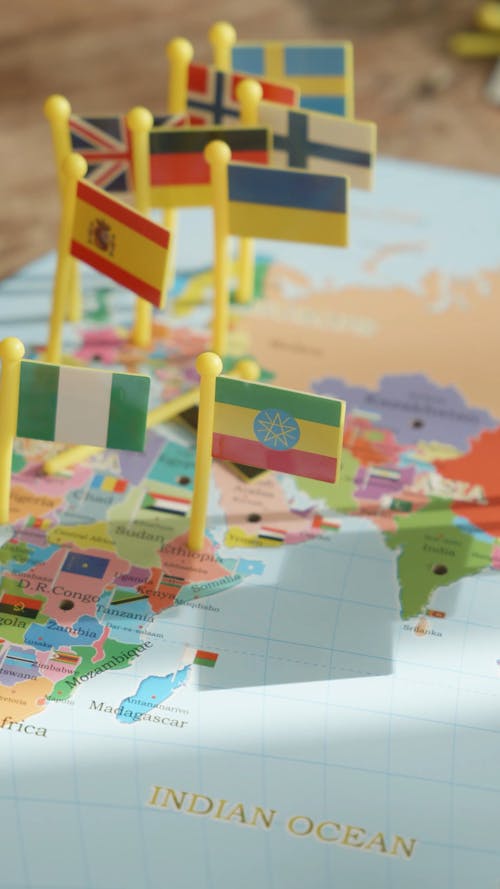 Close up of a World Map with Small Flags