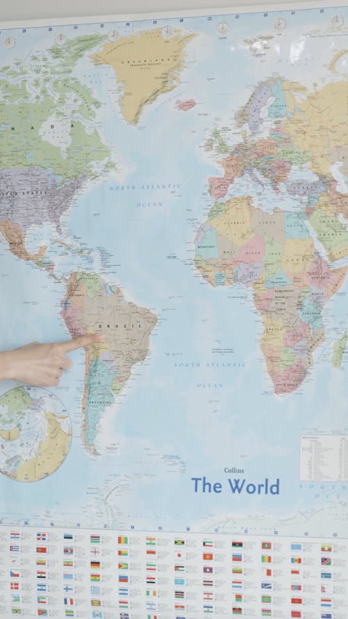 People Pointing Continents on a Map