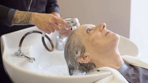 Elderly Woman Getting Her Hair Wash