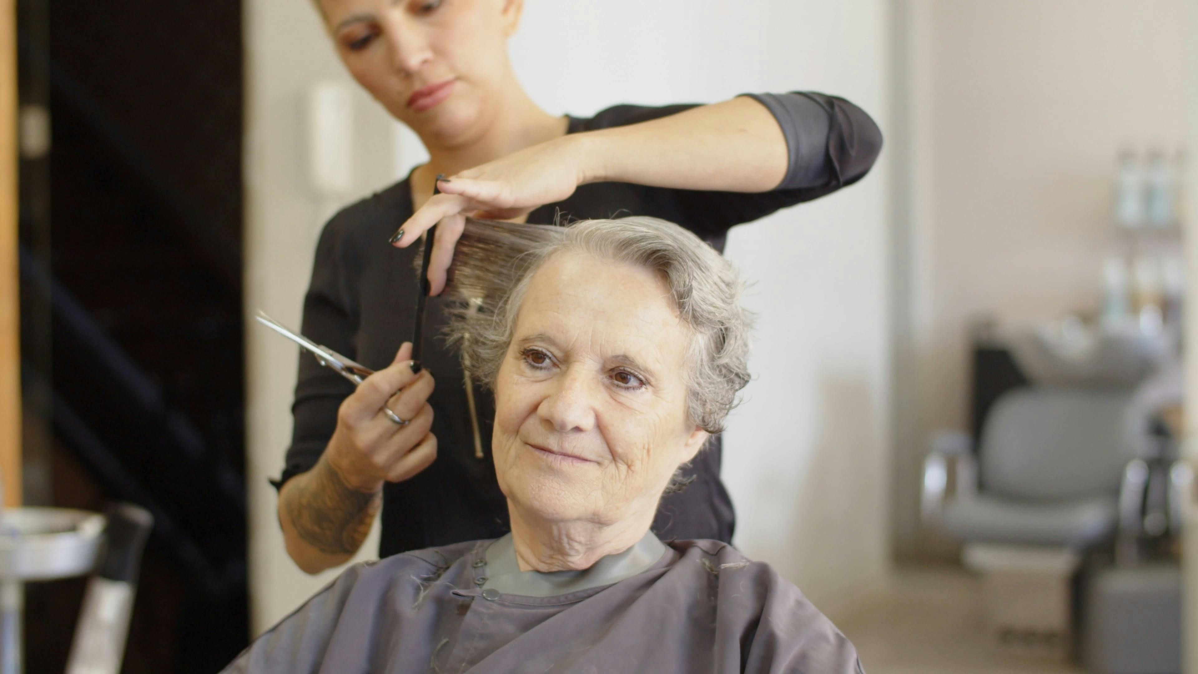 Female Hairdresser Cutting an Elderly Woman's Hair Free Stock Video Footage, RoyaltyFree 4K