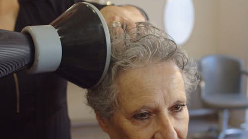 Close Up Video of an Elderly Woman Getting Hair Dry