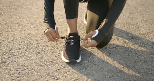 A Person Tying Their Shoelaces