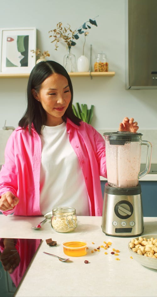 Woman Using a Blender in the Kitchen