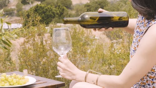 Woman Pouring Wine in a Wine Glass