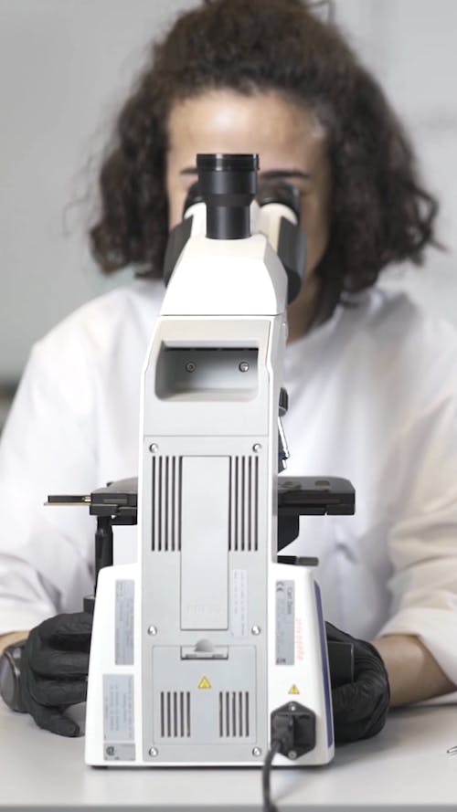 A Chemist Woman Looking Through the Microscope